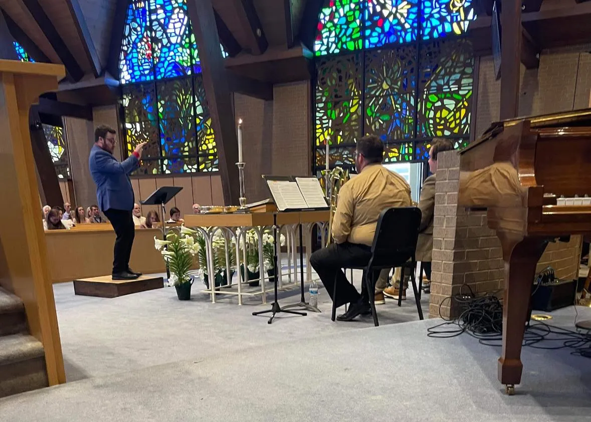 Frazier Smith conducting a music ensemble — a literal music classroom, before the AI lab
